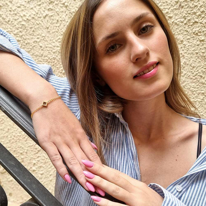 Gold jewelry for her featuring geometric rhombus and scripture inside